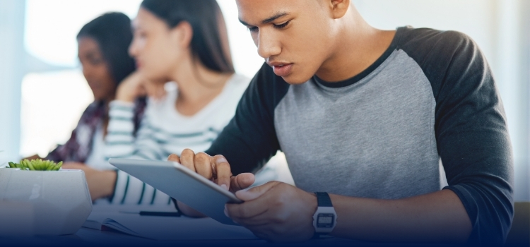 Male student studying on an i-pad