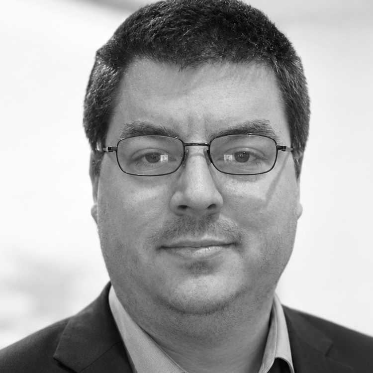 A black and white photograph of John Hansen attempting to smile professionally. 😶