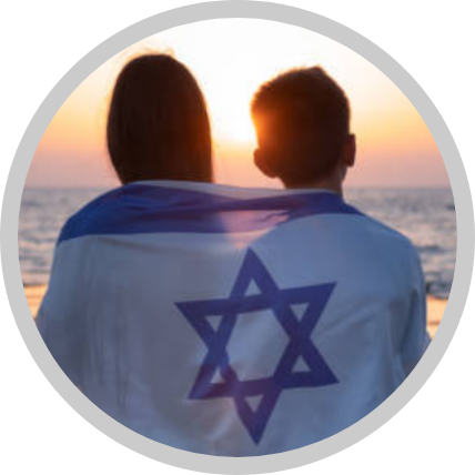 2 children wrapped in an Israeli flag in front of a sunset