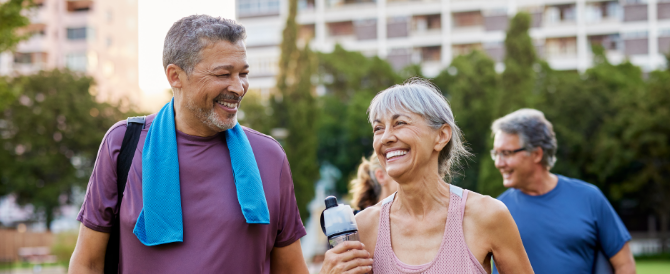 An older couple smiling while on a walk
