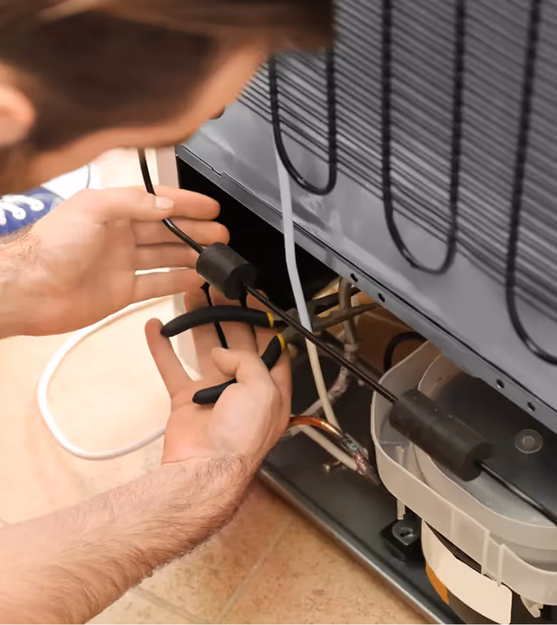 technicin repairing refrigerator