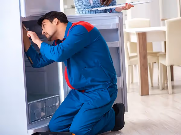 technician repairing a freezer