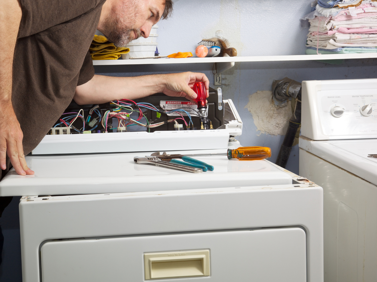 Technician repairing a dryer