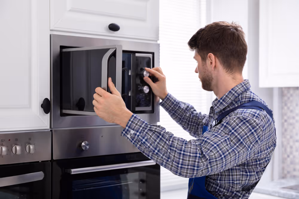 technician repairing a microwave