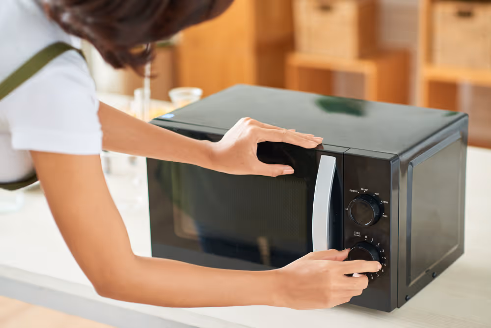 technician repairing a microwave