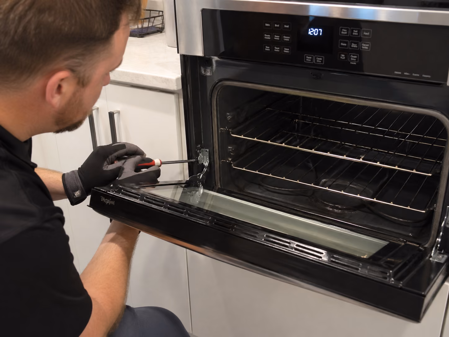 technician repairing a whirlpool oven