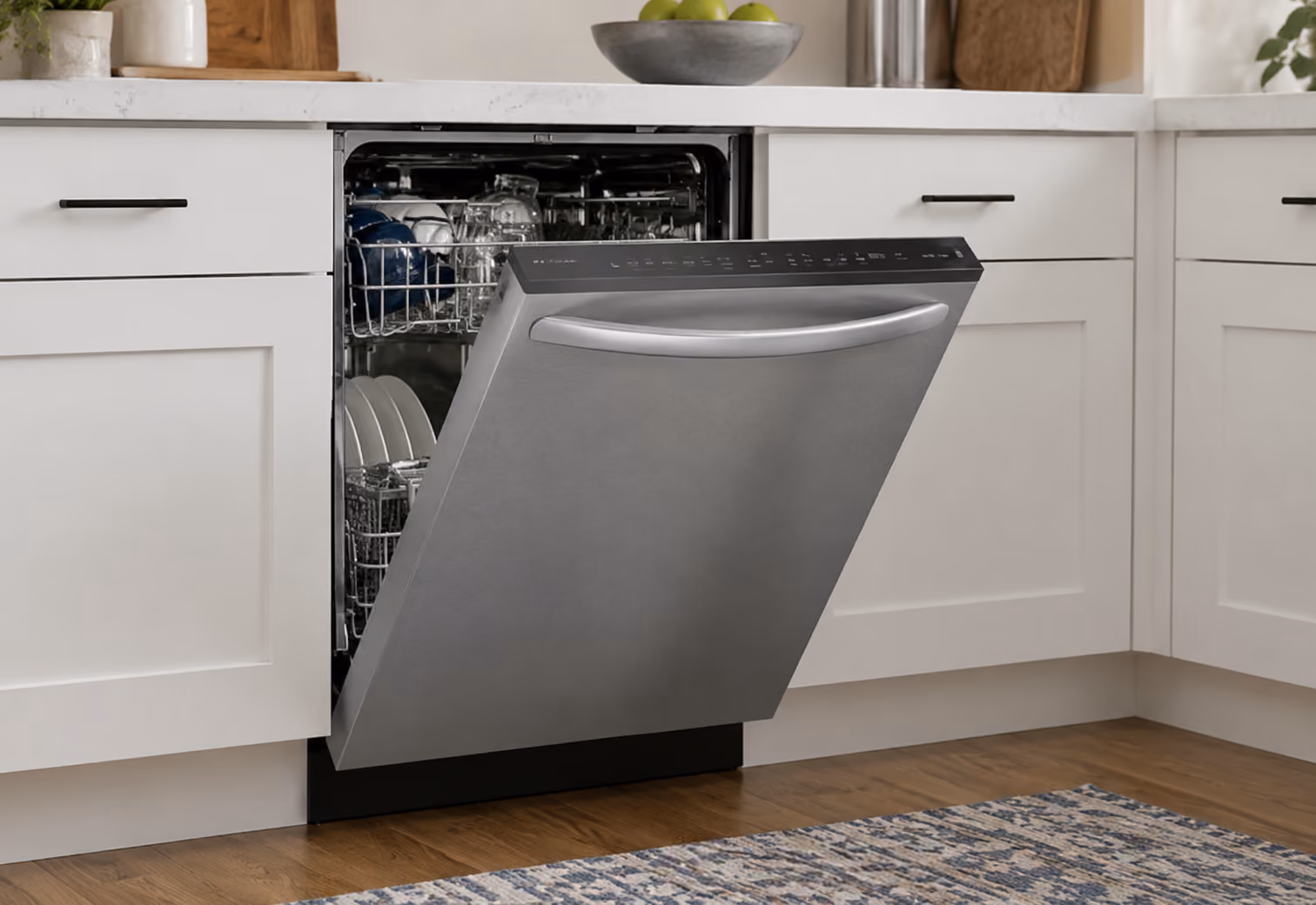 Frigidaire stainless steel dishwasher open in a modern white kitchen