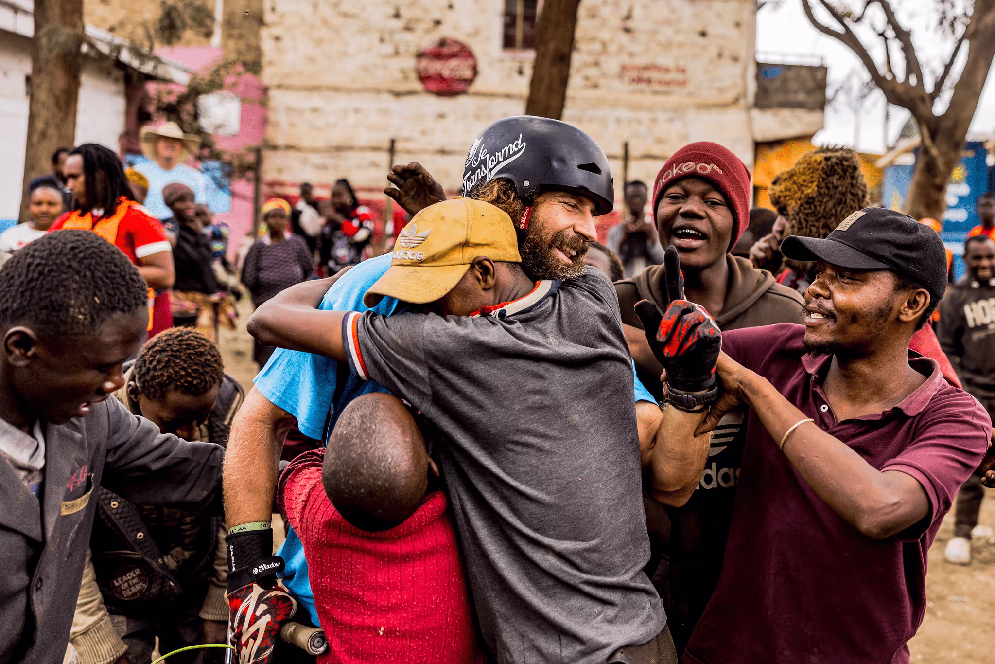 Group of people smiling and hugging each other in an outdoor setting