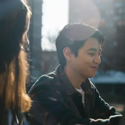 Student studying outdoors with a friend, using microlearning to prepare for certification exams.
