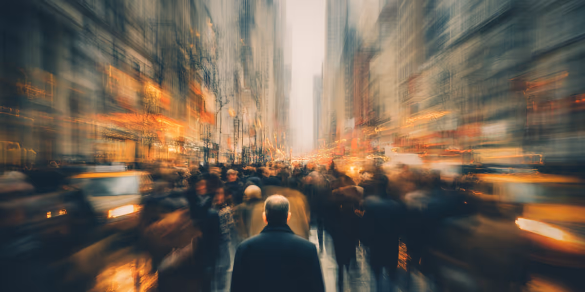 blurry image of man walking down the sidewalk in a busy urban street