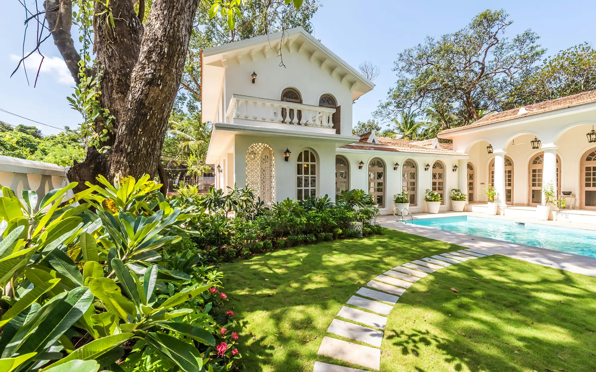 Custom home exterior with pool and tropical landscaping in Southwest Florida
