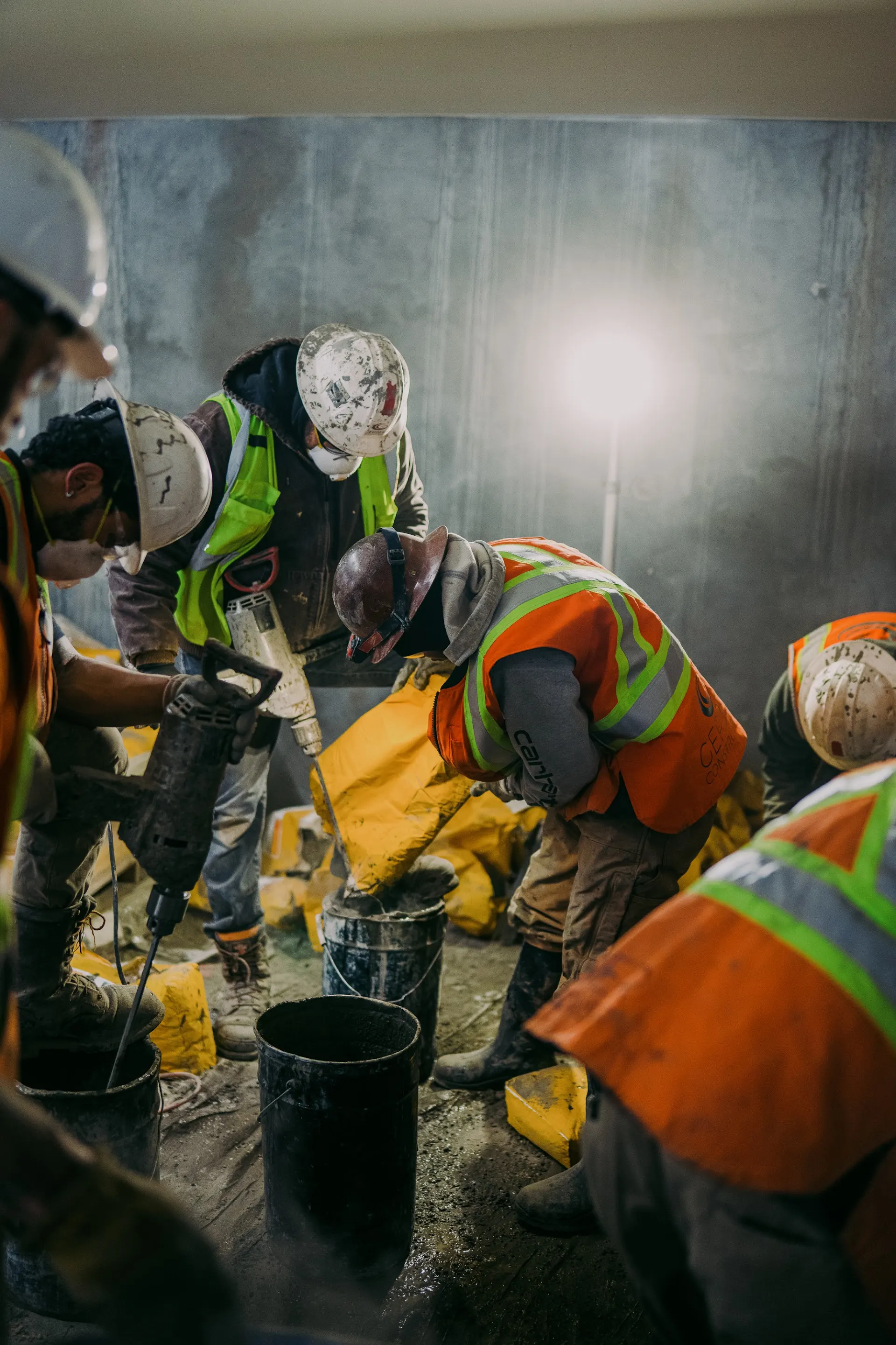 Gerber crew members mix concrete repair material inside a parking garage.