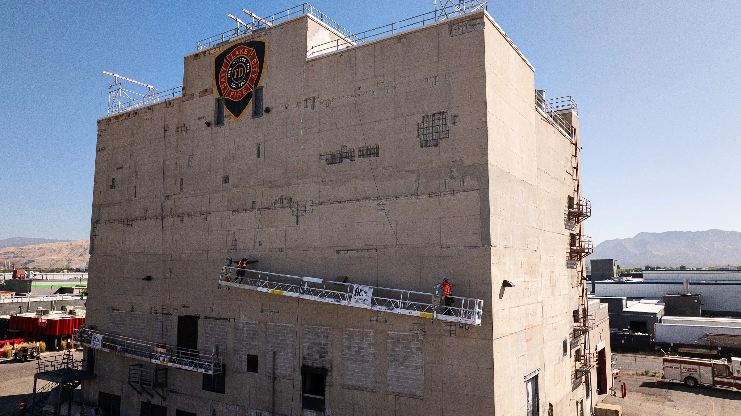 Weathered, patched concrete with rust stains on a tower wall, the kind of damage that needs a site visit.