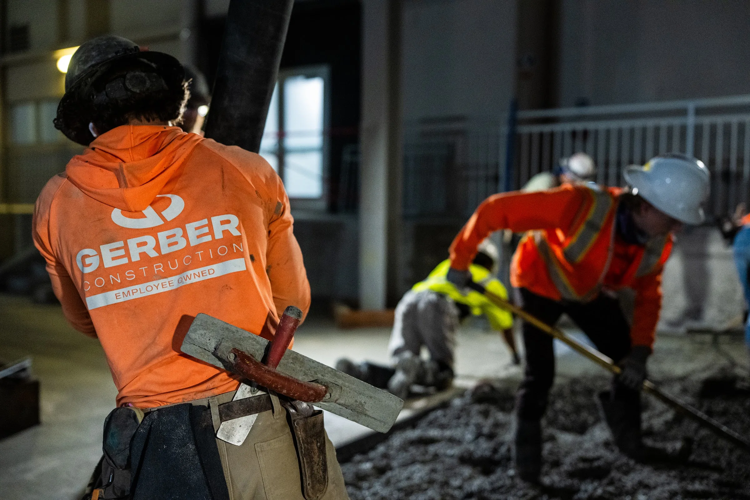 A Gerber crew member finishes concrete on a campus stadium concourse.
