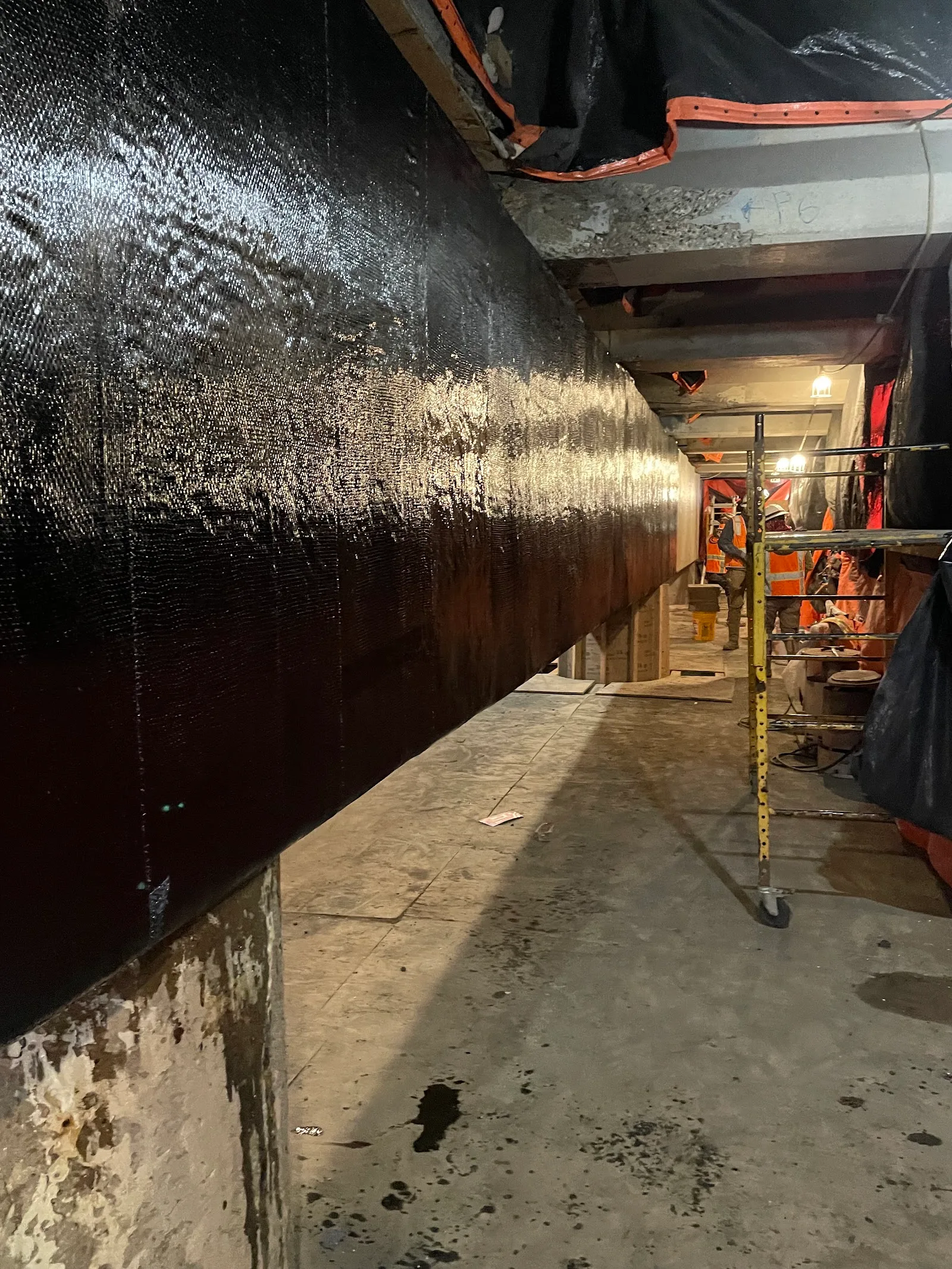A bridge beam wrapped in carbon fiber after concrete repair.