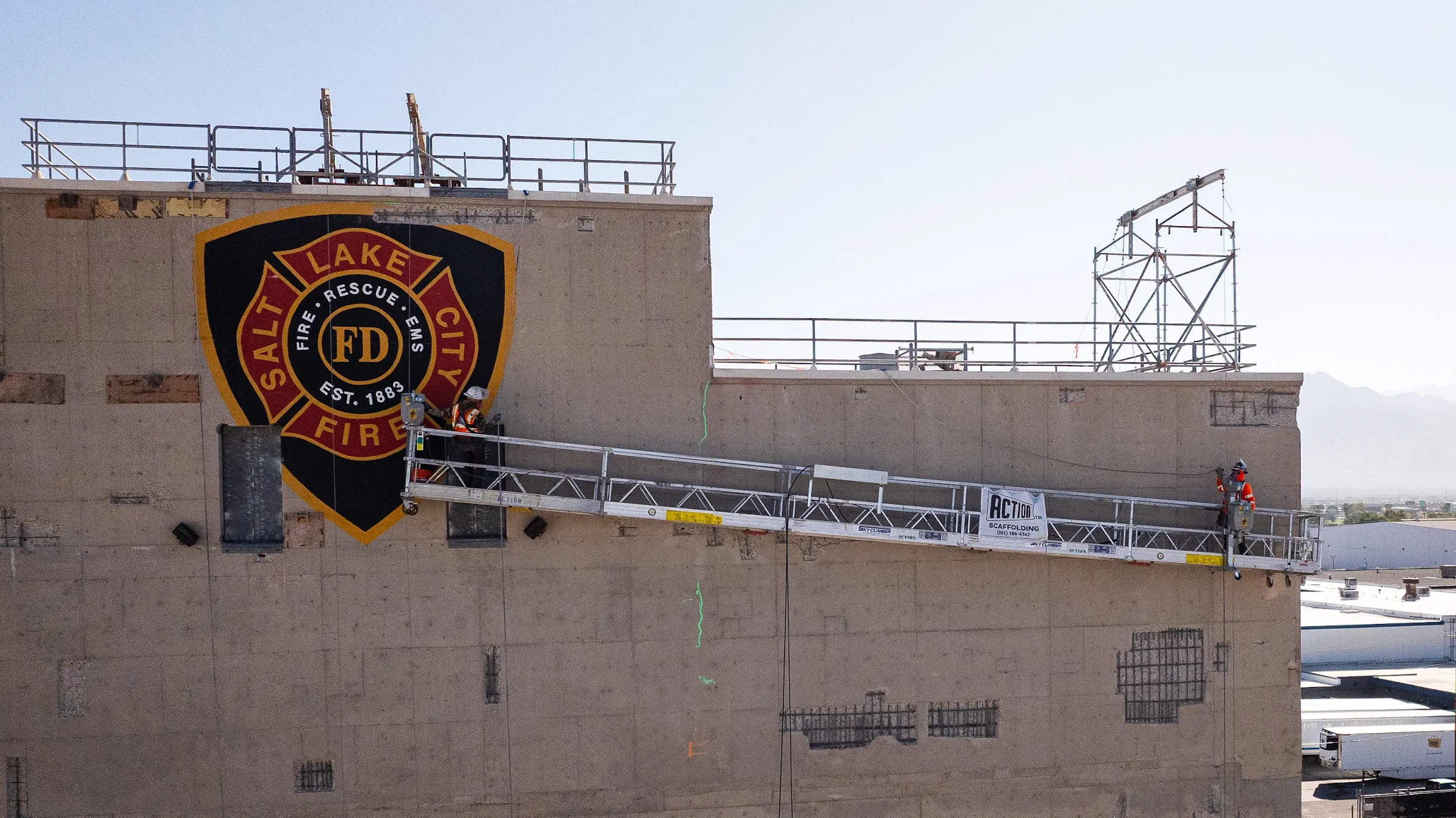 Before: a Gerber crew on a swing stage repairs patched, weathered concrete on a fire station training tower.