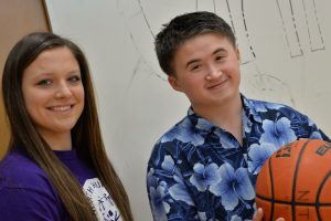 Teen girl and boy with basketball, smiling