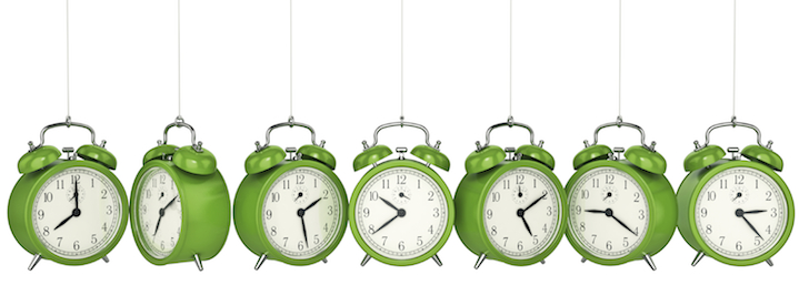 apple green clocks hanging from chains, each displaying a different time