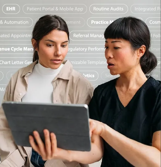 Two women reviewing information on a tablet, with healthcare terms blurred in the background.