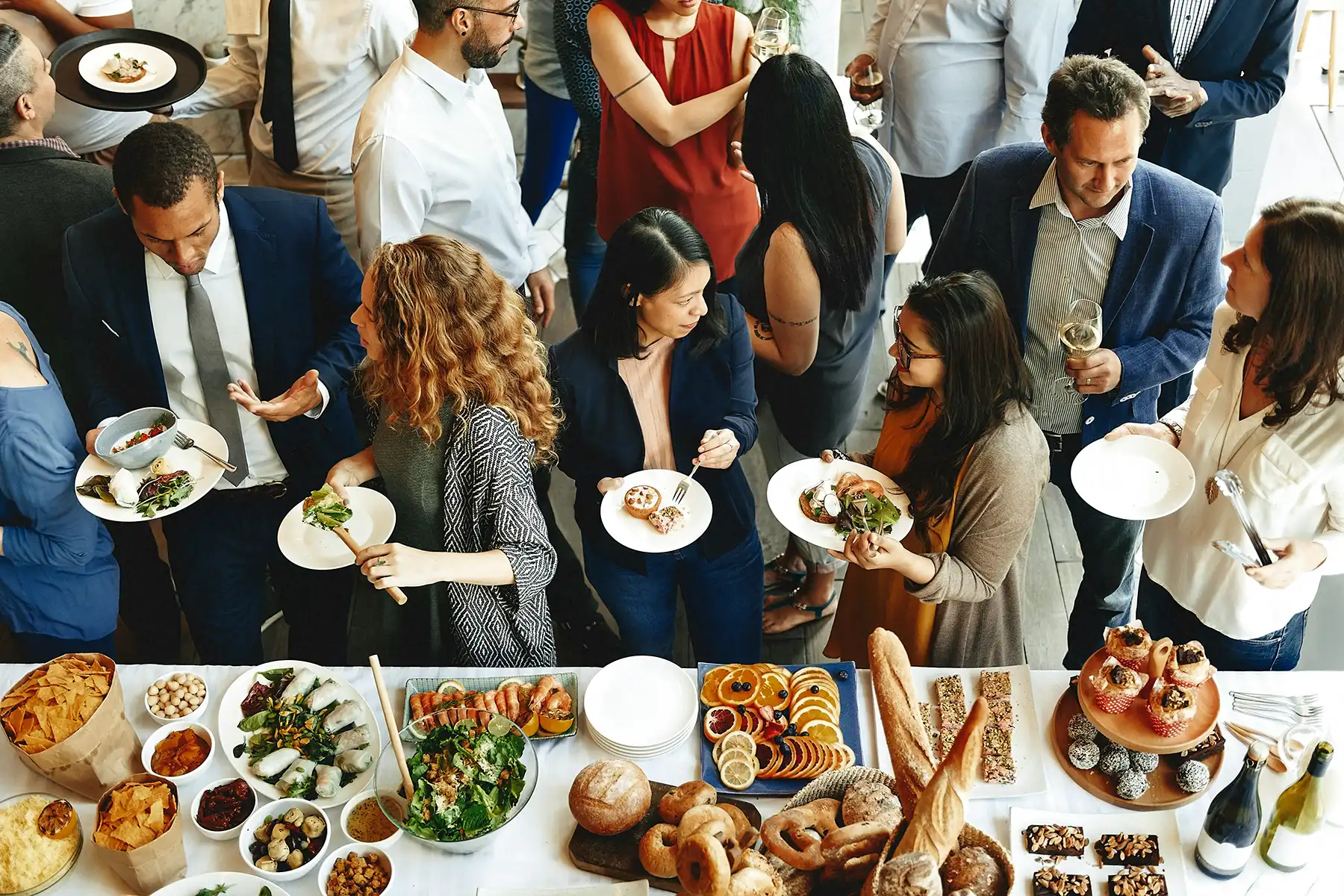 A large group of coworkers at a buffet for a corporate event at Millrace