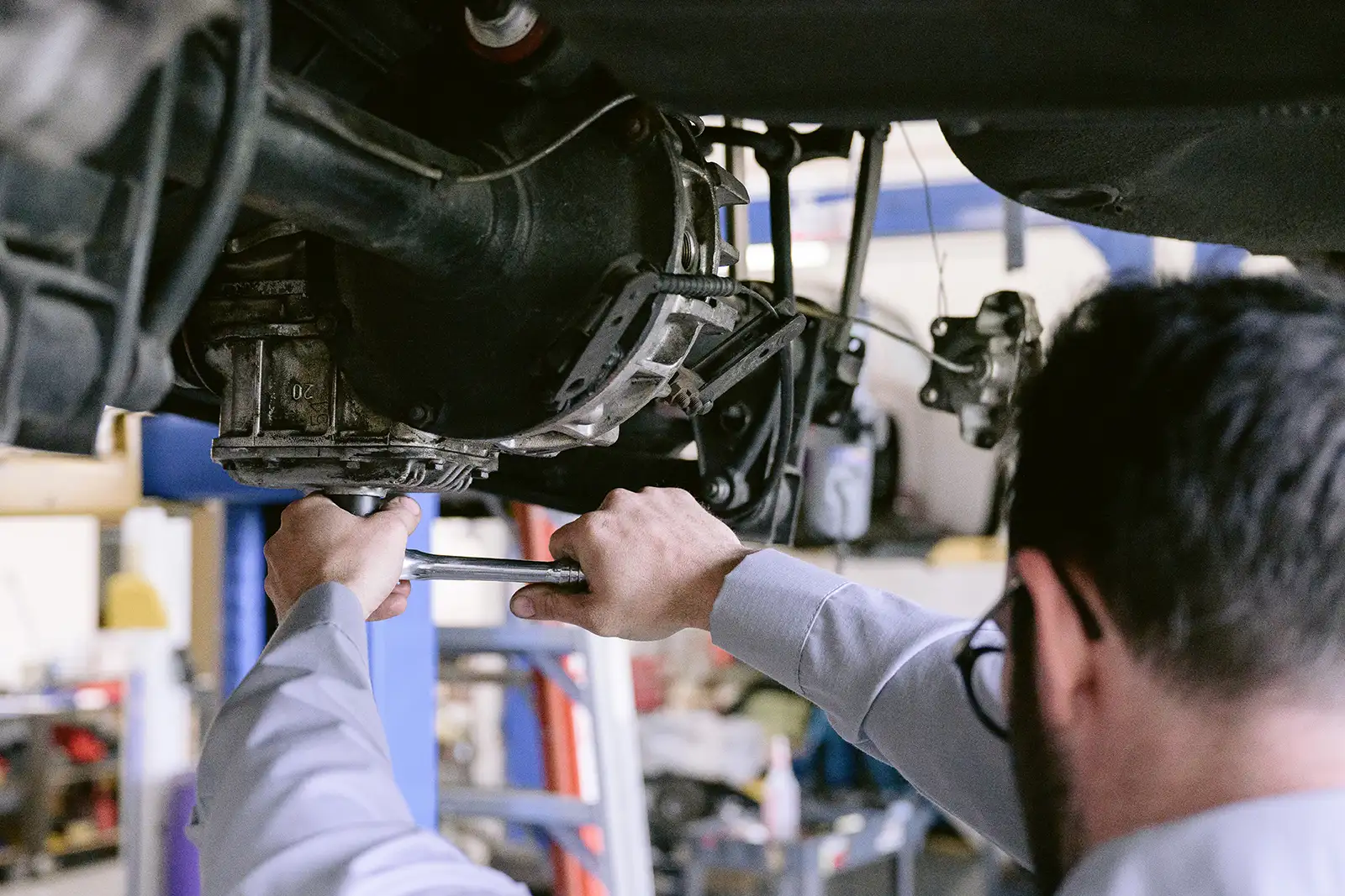 A mechanic torquing a bolt on a transmission