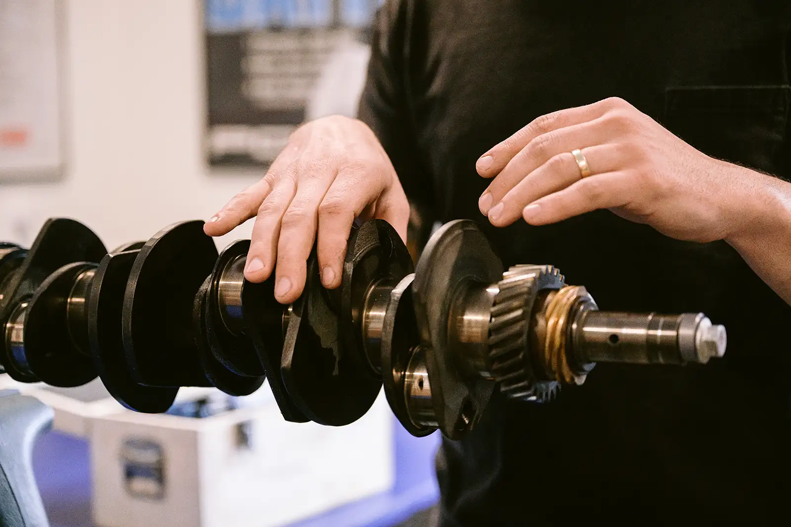 A man inspecting engine internals for a rebuild