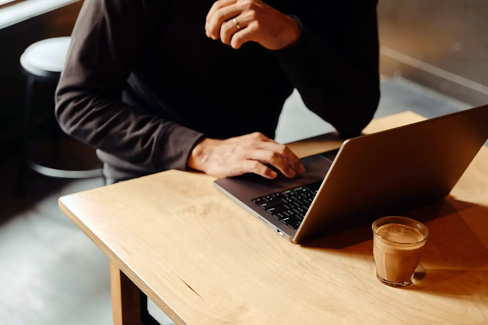A person on a laptop doing listing management for Millrace auctions
