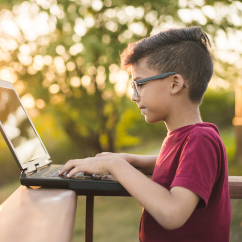 kid on laptop in sun.jpg