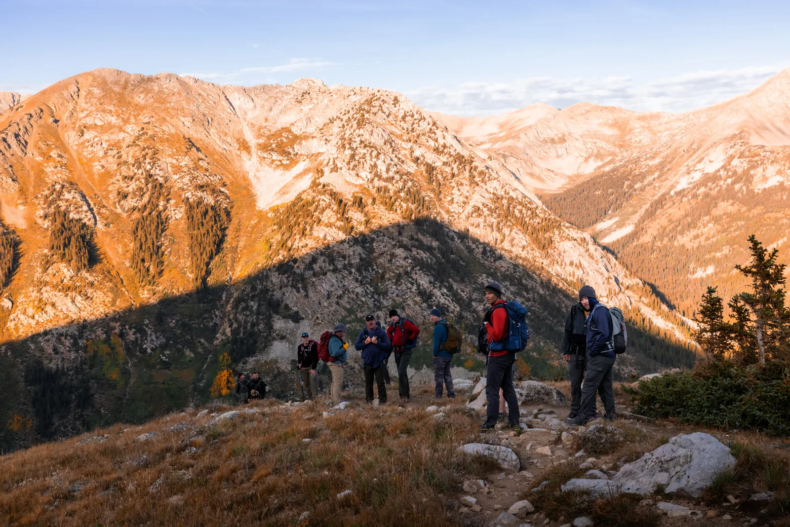 Retreat group on a Rockies ridge at golden hour