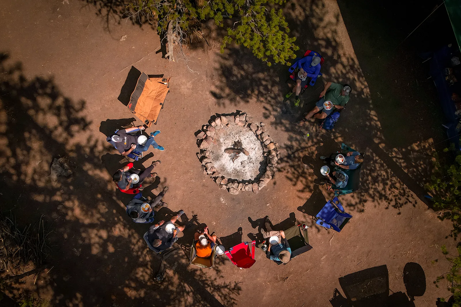 Overhead view of a Summitwise retreat gathered around the campfire circle