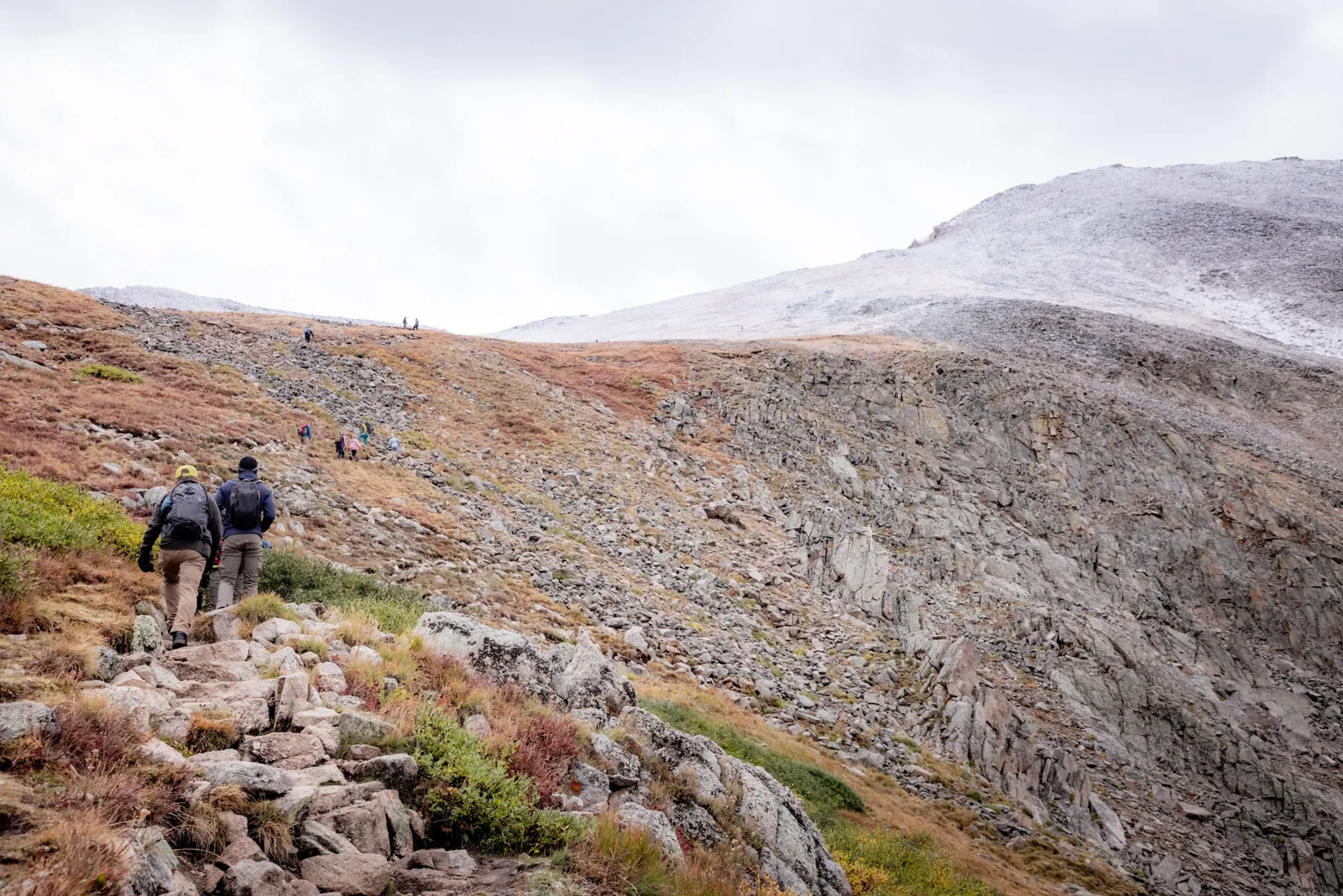 Ascending a rocky, snow-dusted slope