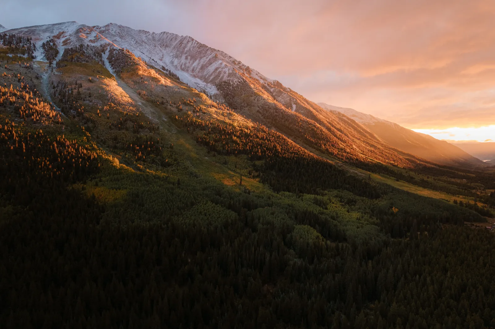 Sunset light on a snow-capped Rockies ridge