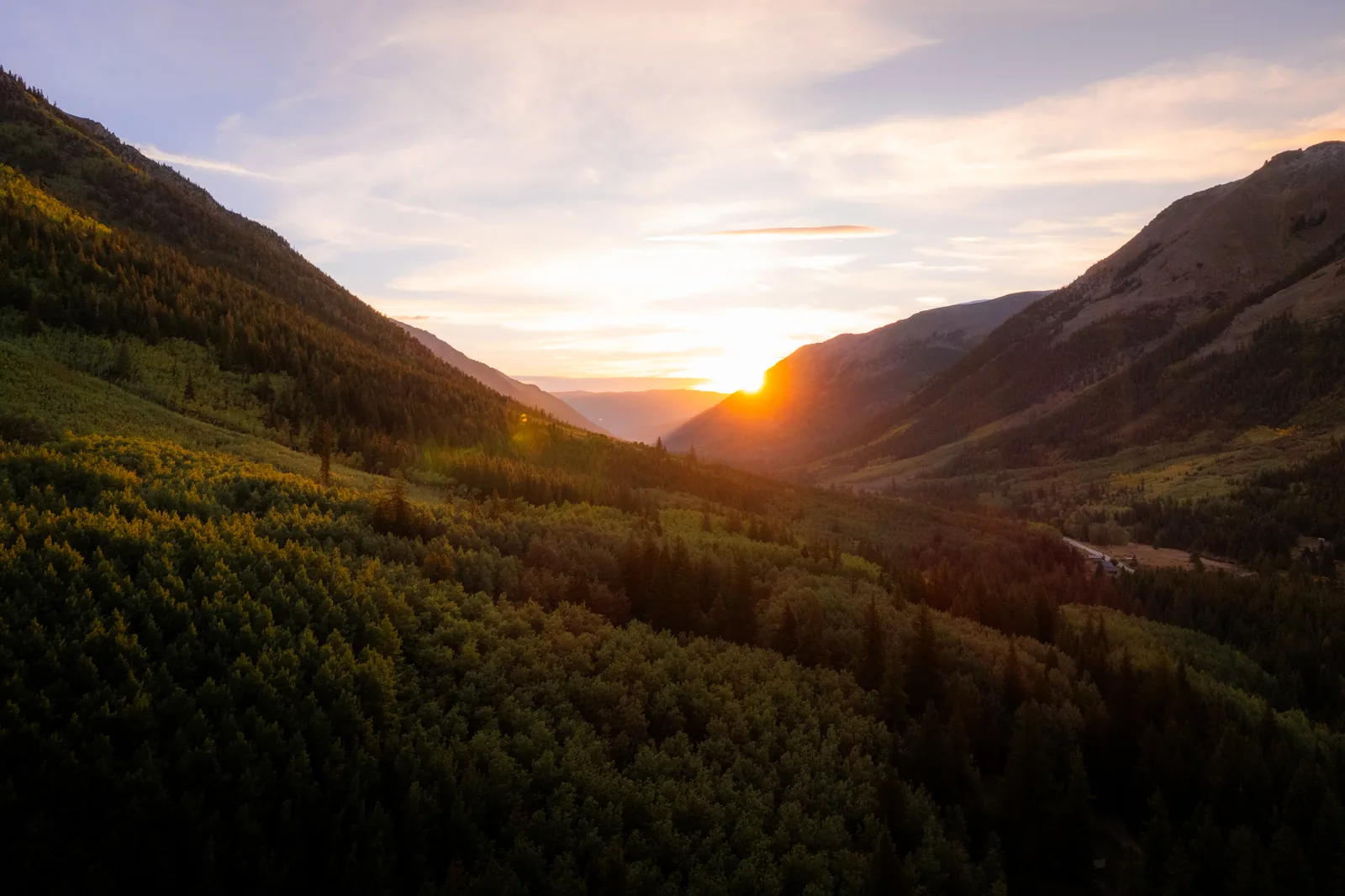 Sunrise breaking over a mountain valley