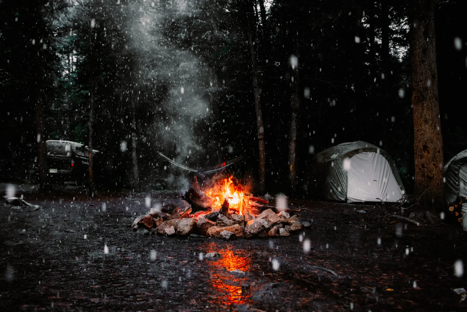 The group gathered around the campfire in the rain