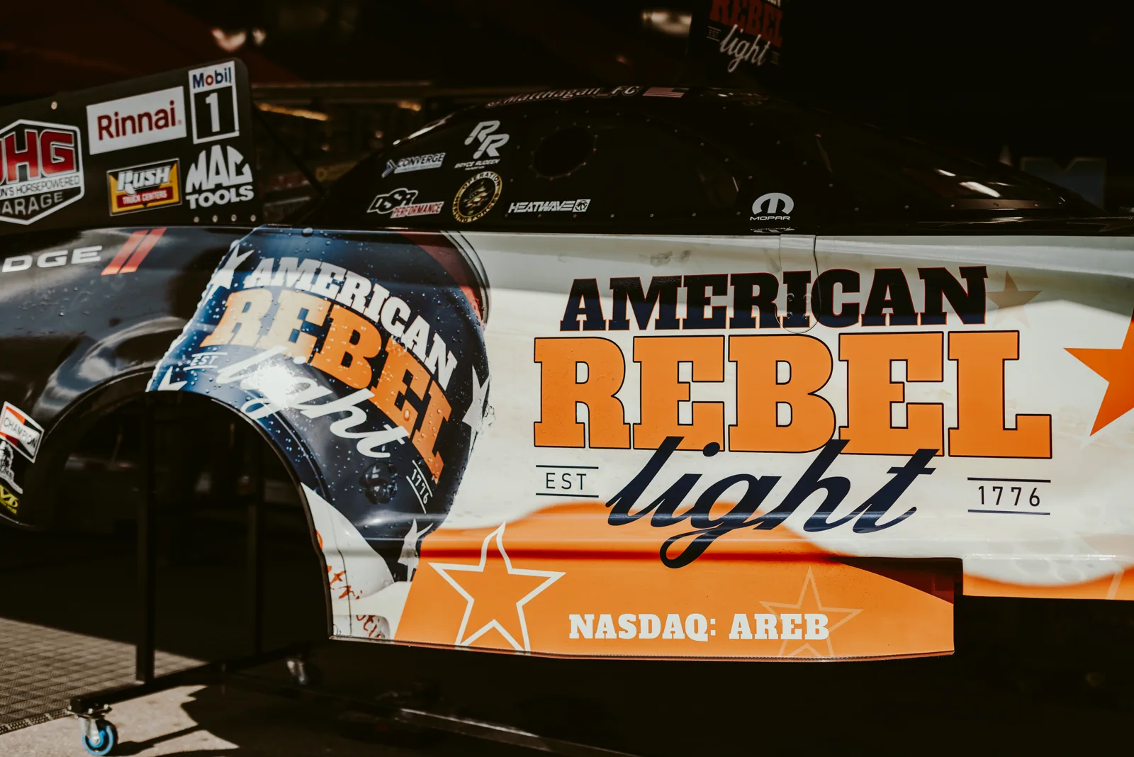American Rebel Light NHRA funny car livery with the AREB ticker