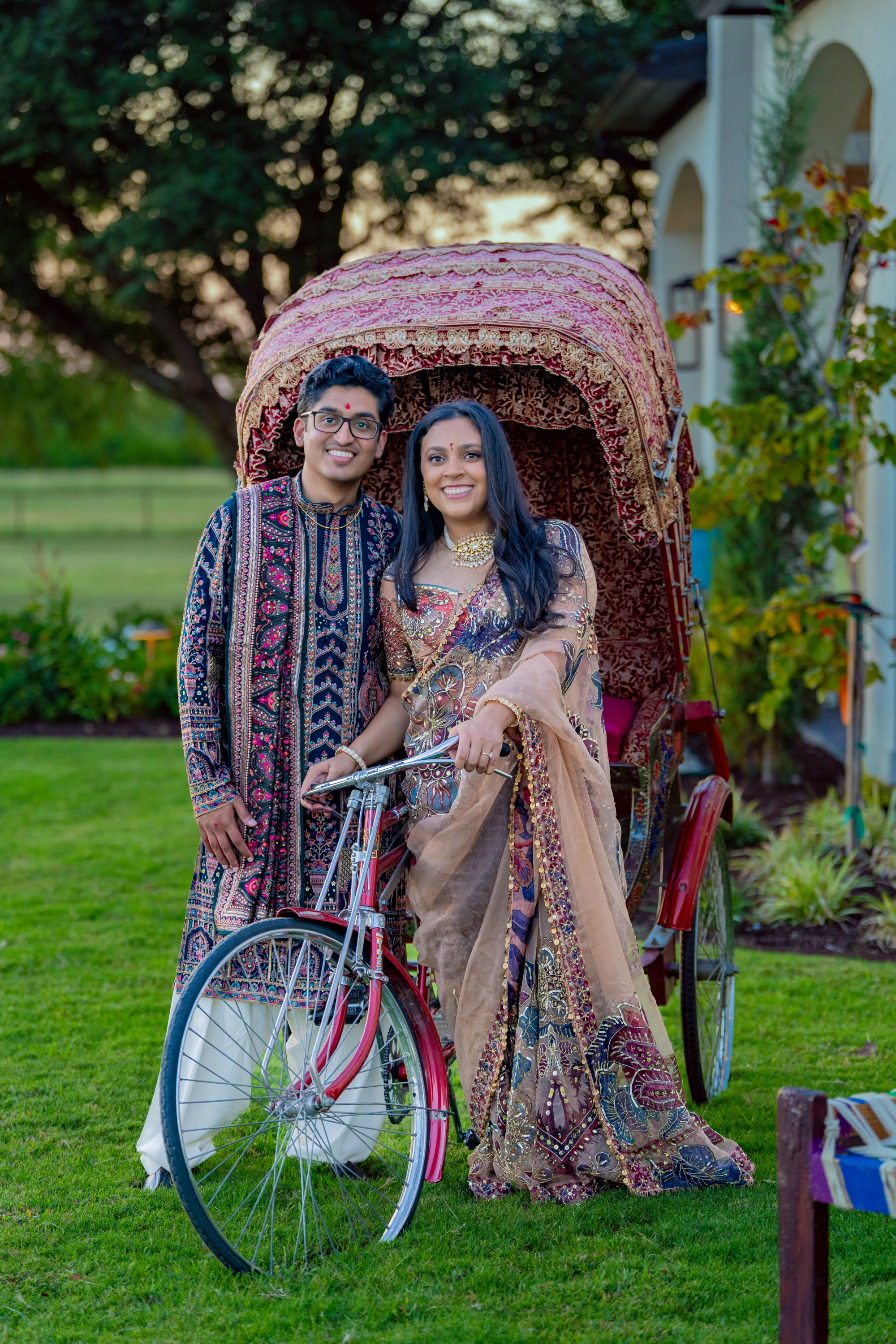Suyash and Shruti posed in front of a cycle