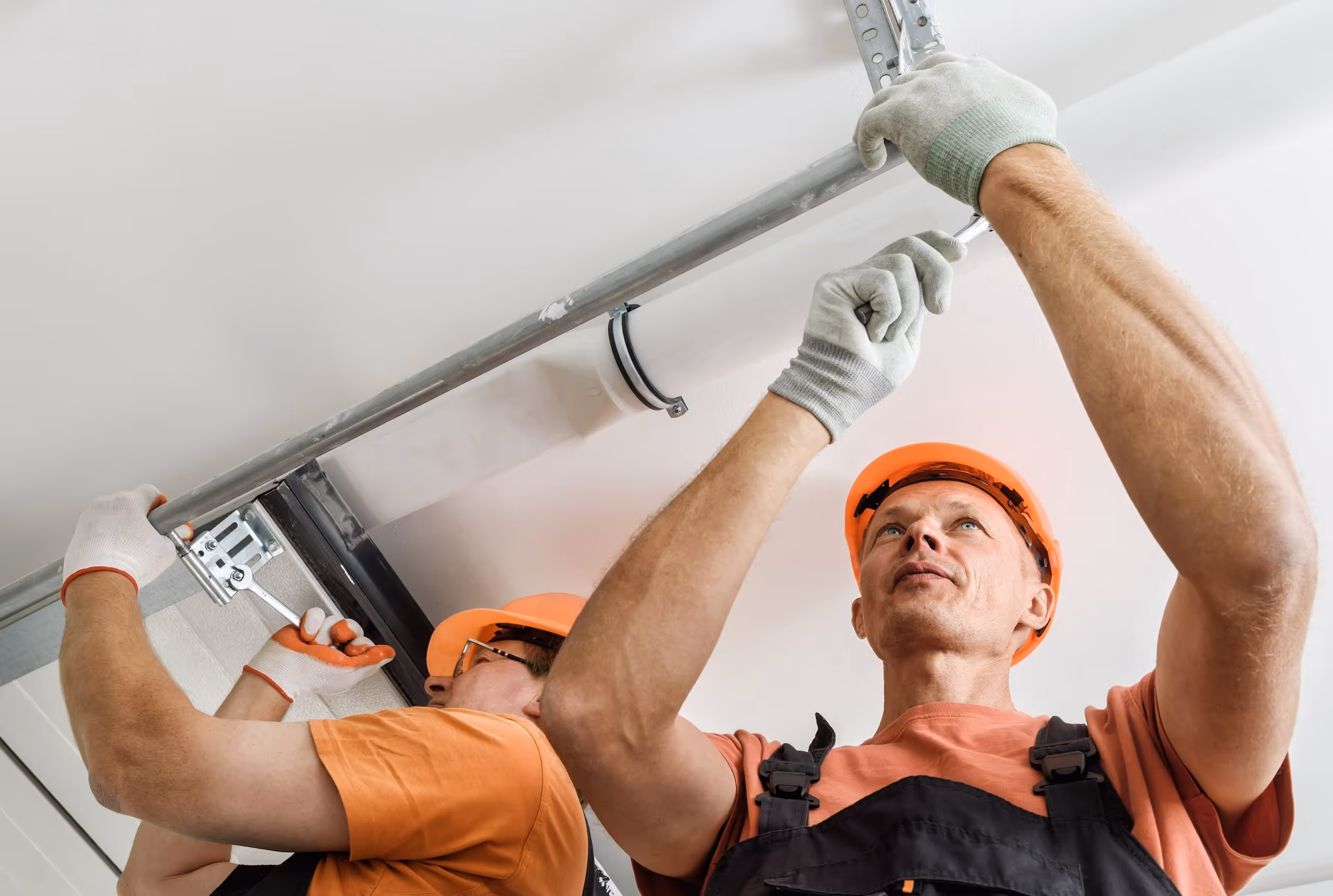 A group of technicians working on a newly installed garage door.