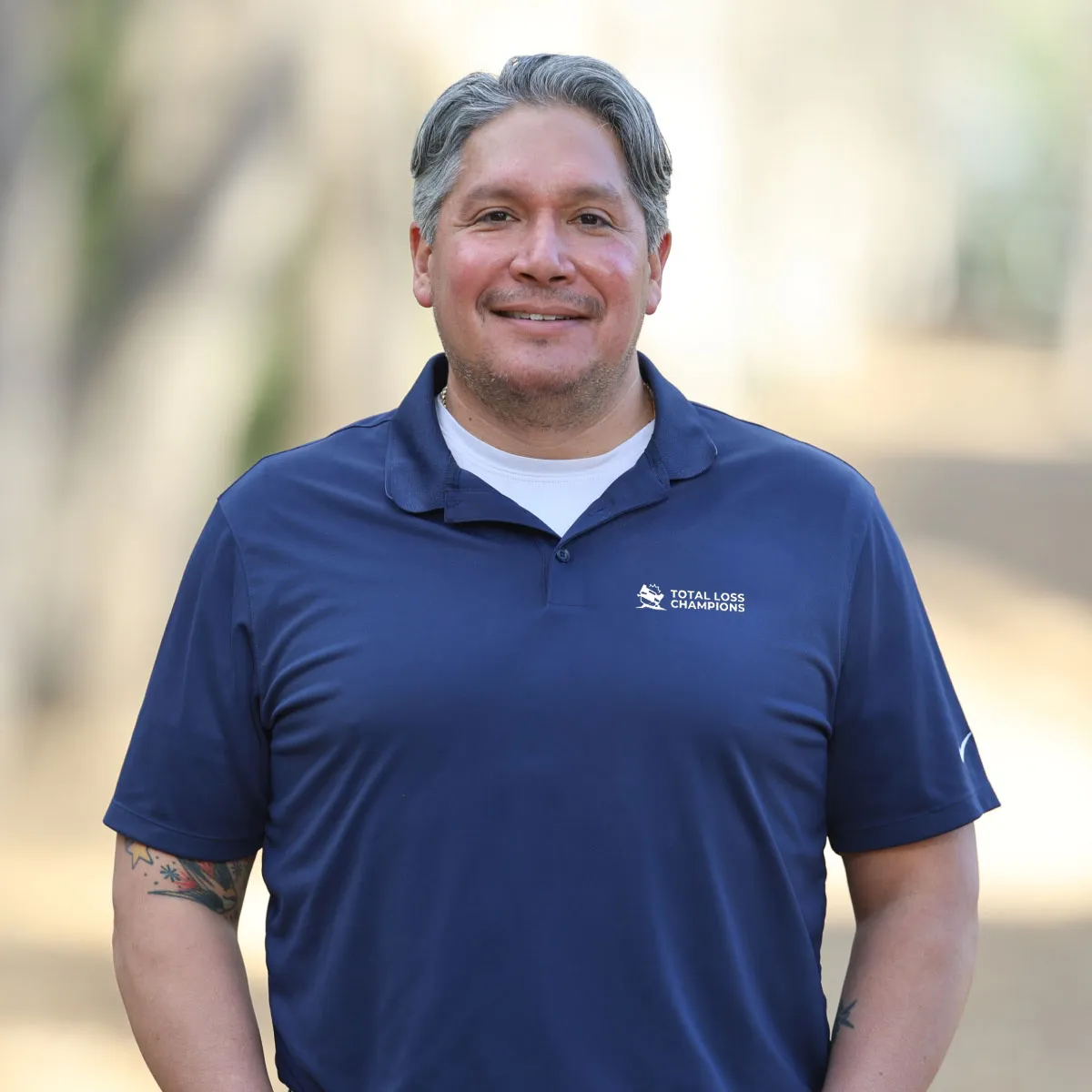 Aaron Castillo owner of Total Loss Champions waist up portrait