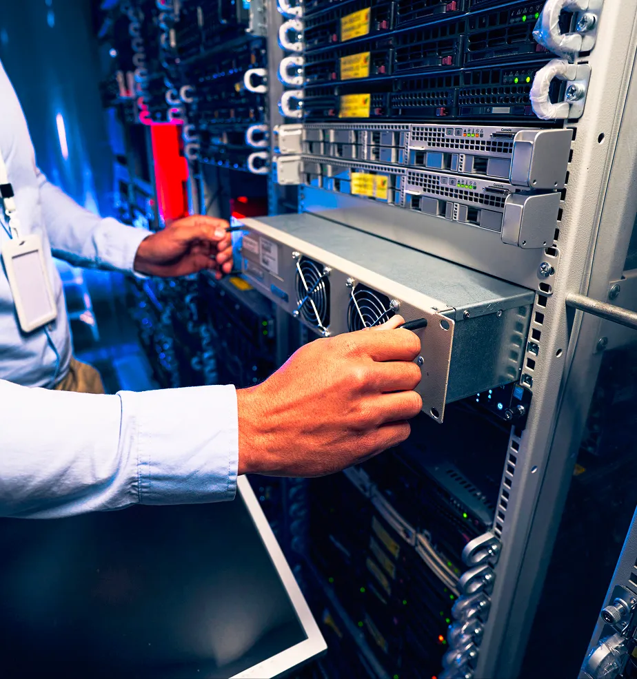 Technician installing or removing a server unit in a data center rack.