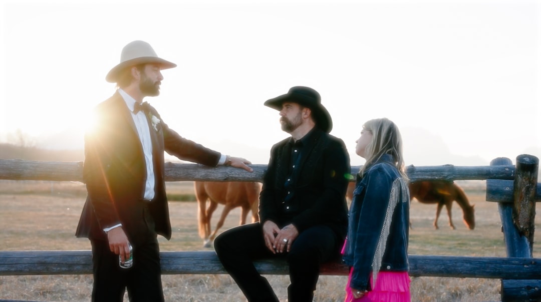 Multi-generational ranching family standing together on their land - American cowboy ranch life Multi-generational ranching family standing together on their land - American cowboy ranch life