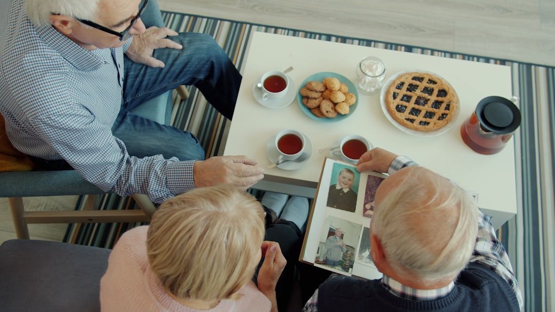 A multi-generational family looking at a vintage map together, sharing stories - legacy tour A multi-generational family looking at a vintage map together, sharing stories - legacy tour