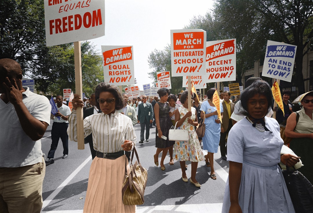 Peaceful civil rights marchers holding hands and walking together Peaceful civil rights marchers holding hands and walking together