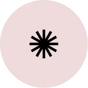 Black asterisk symbol centered on a light pink circular background.