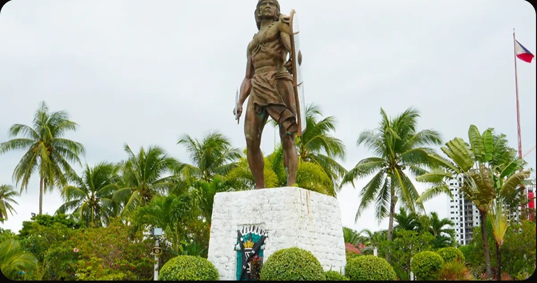 The Lapu-Lapu monument at Mactan Shrine, framed by palms