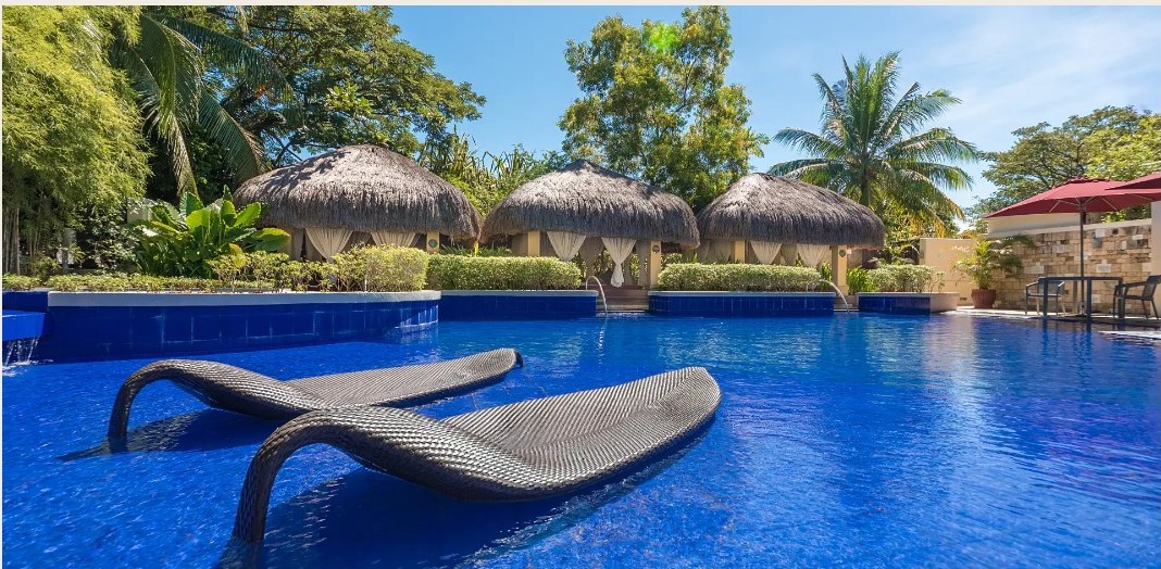 Pool and thatched cabanas at Crimson Resort & Spa Mactan
