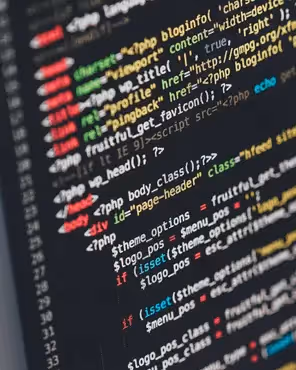 Close-up of computer screen displaying colorful HTML and PHP code for email or web development.
