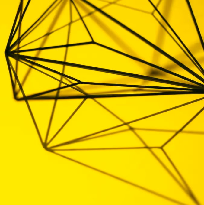 Abstract geometric wireframe on vibrant yellow background, symbolizing creative tools and essential resources for modern email designers.