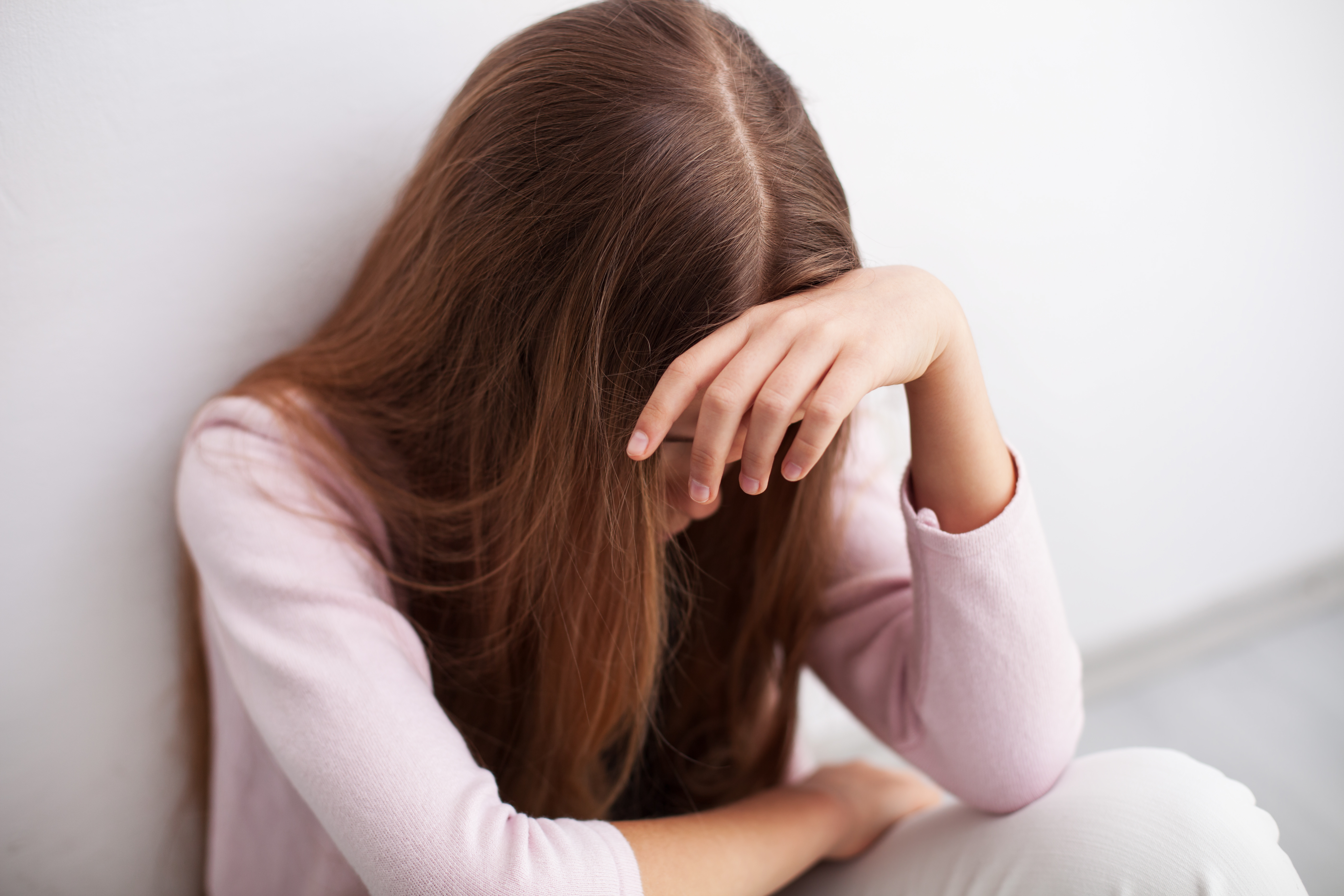 A young girl looking upset