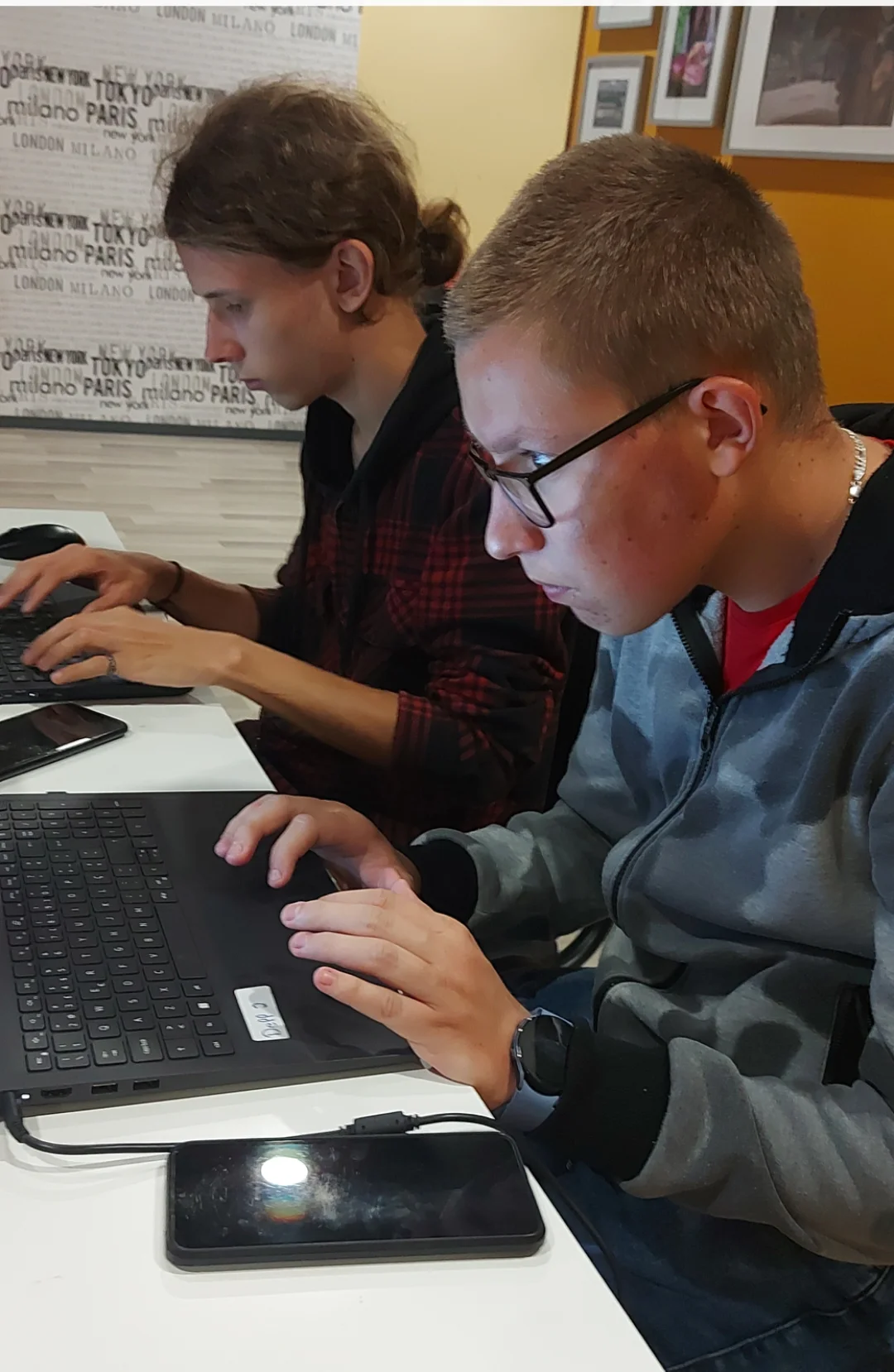 An injured boy uses a computer