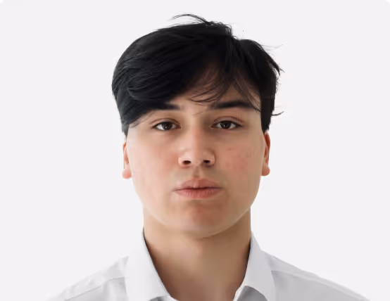 Headshot of a young person with dark hair wearing a white collared shirt against a plain white background.